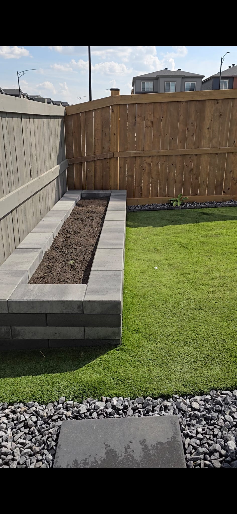 Natural stone retaining wall and raised garden bed — West Edmonton